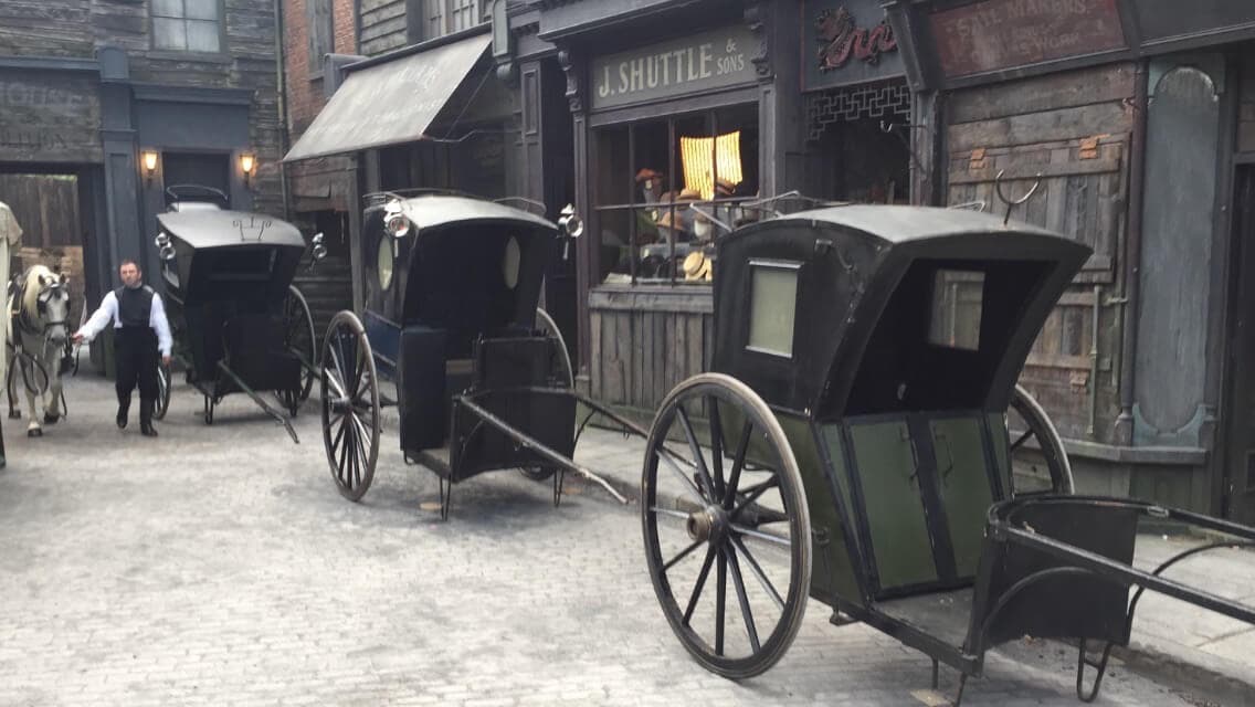 Period hansom cabs lined up on a Victorian street set