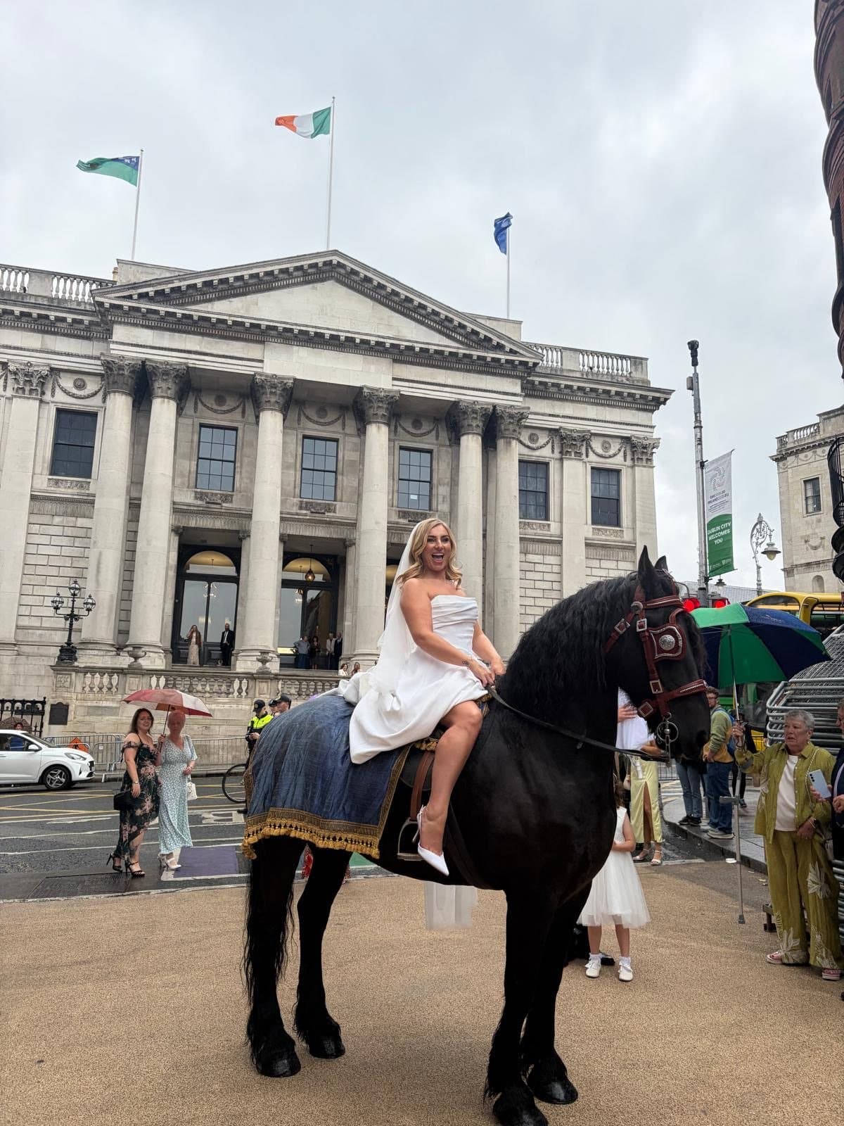 Olivia Fanning in her wedding dress, mounted on Romeo outside Dublin City Hall